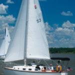 With Jane Wilson at the helm and owners Bryan Schulte and Gary Smith trimming the sails, Rozinante, a Bristol 29.9, joins the fleet enjoying balmy conditions on Rathbun Lake, Iowa.