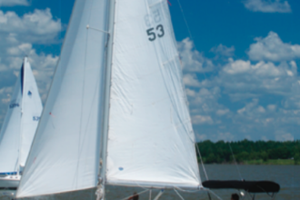 With Jane Wilson at the helm and owners Bryan Schulte and Gary Smith trimming the sails, Rozinante, a Bristol 29.9, joins the fleet enjoying balmy conditions on Rathbun Lake, Iowa.