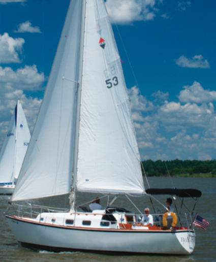 With Jane Wilson at the helm and owners Bryan Schulte and Gary Smith trimming the sails, Rozinante, a Bristol 29.9, joins the fleet enjoying balmy conditions on Rathbun Lake, Iowa.