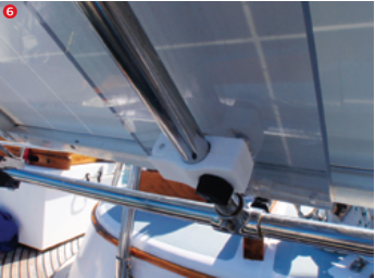 I fastened plastic rail clamps to the acrylic backing, approximately 3 inches from each end. I then used the clamps to attach the solar panels to the extended legs of the T-assemblies.
