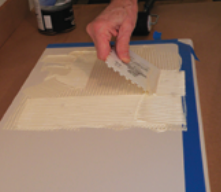 Next, Stephen used a notched trowel to spread the paint across the surface.