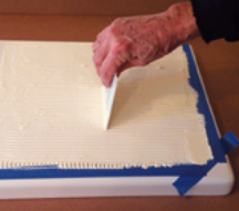 Still using the spreader, Stephen covered the entire surface with an even coating.