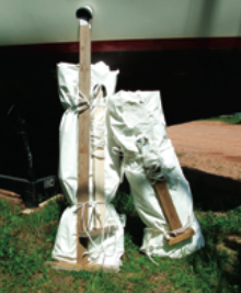 Stern and bow, two complete sets are bound up and ready for next year: shrinkwrap film, frame posts, stanchion padding, and strapping. All Paul will need in the fall is a roll of tape, a little shrinkwrap film for making patches, and a dry day for doing the job.