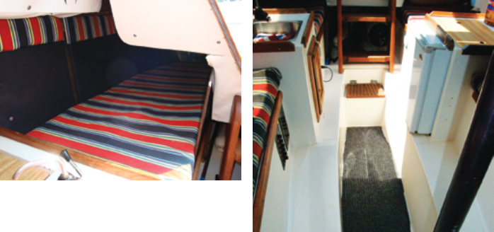 The quarter berths under the cockpit seats, above, are a little wider than the settees in the saloon. By recessing the cabin sole into the keel, Lancer gave this low-profile boat nearly 6 feet of standing headroom, at right. Behind the ladder is a large space for stowing bulky items. The bottom step hinges up to reveal the bilge pump.