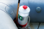 A length of PVC pipe contains the dinghy anchor and displays the decals required by law.