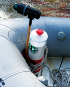 A length of PVC pipe contains the dinghy anchor and displays the decals required by law.