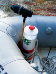 A length of PVC pipe contains the dinghy anchor and displays the decals required by law.