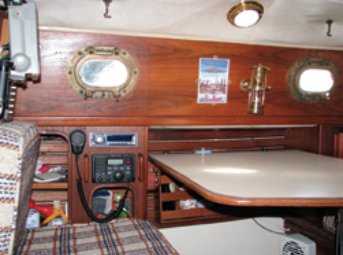 Sisiutl’s main cabin is small but cosy. Steve’s custom radio installation can be seen outboard, and the massive bronze ports suggest the boat’s seagoing ambitions.