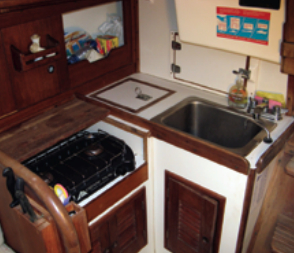 The galley is laid out reasonably well, given the limited space in a 30-foot boat, but the sink is partially tucked under the cockpit, which hampers leaning over it to work.