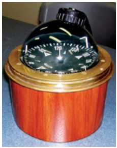 The finished binnacle in varnished mahogany sets off the vintage compass perfectly.