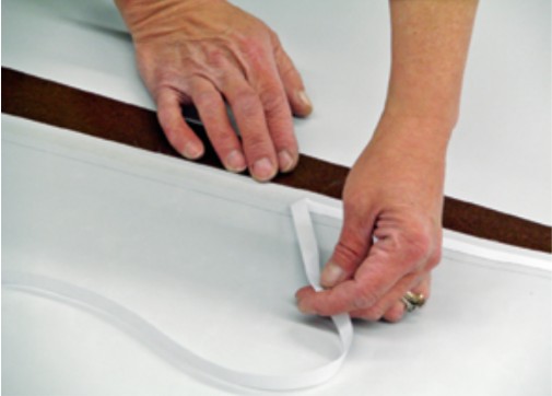 A double-sided basting tape applied along the marked seam allowance can be used to secure the panels together before sewing.