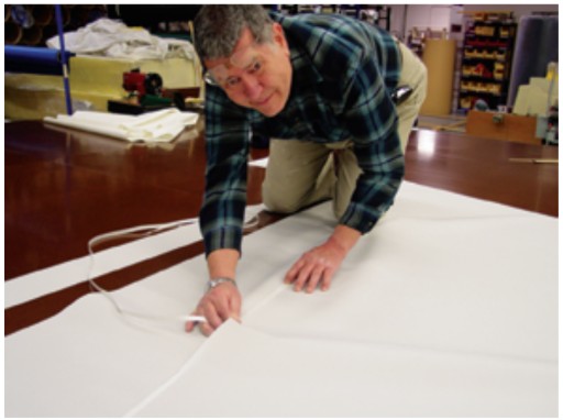 Jim Grant (Sailrite’s founder) bastes panels together. This step is critical to proper sail shape. If there is any inaccuracy here, it will be reflected in the shape of the sail. Fortunately, any errors can easily be rectified at this point by simply lifting the sail panels apart and repeating the process.