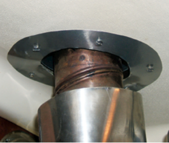 Metal trim rings shield the deck from the hot flue.