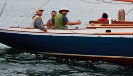 The crew of Mary Loring, a custom wooden yacht owned by Leonard Sinowitz, are all smiles.
