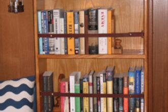 An avid reader and hands-on sailor, John Lively took matters into his own skilled hands to provide proper quarters for his essential cruising companions: books and tools.