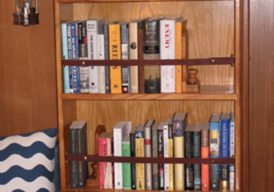 An avid reader and hands-on sailor, John Lively took matters into his own skilled hands to provide proper quarters for his essential cruising companions: books and tools.