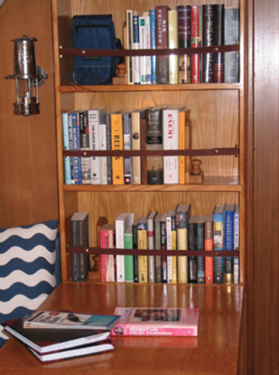 An avid reader and hands-on sailor, John Lively took matters into his own skilled hands to provide proper quarters for his essential cruising companions: books and tools.