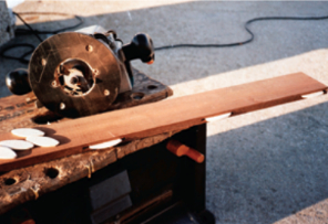 One of the boards, with the biscuits dry-fitted into the grooves, rests on the workbox next to the router, which is fitted with a biscuit-jointing bit, below.