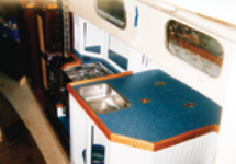 The new galley counter provides a large work surface and encloses an Igloo cooler.