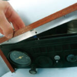 The teak-and-aluminum frame is held in place with the screws that secure the panel, so no new holes had to be drilled into the boat.