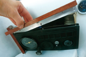 The teak-and-aluminum frame is held in place with the screws that secure the panel, so no new holes had to be drilled into the boat.