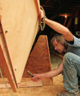 Using copper wire, Dave stitches the plywood components together prior to gluing them.