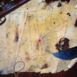 A tattered remnant of canvas bears the secret to where an intrepid father-and-son crew buried a hoard of treasured belongings.