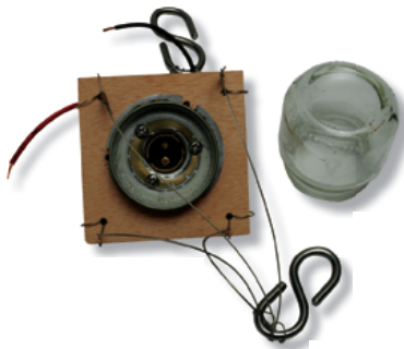 A baby-food jar, its lid screwed to the plywood base, makes a protective lens for the anchor light, which uses the 1142-base LED bulb shown on page 56.