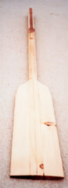 A roughed-out oar awaits refining touches to its shape.