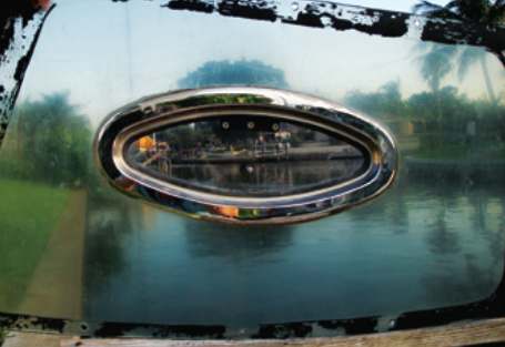 An acrylic port mounted in the center of a now sun-fogged non-UV-protected polycarbonate window provides a good comparison of how the two types of plastic withstand weathering.
