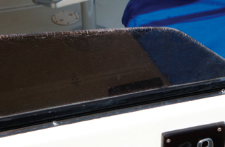 Over time, stress crazing has developed along the edge of this acrylic windscreen. It is most likely the result of overheating during fabrication caused by incorrect cutting or polishing.