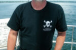 Picture of a man at a boat helm