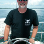 Picture of a man at a boat helm