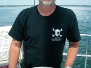 Picture of a man at a boat helm