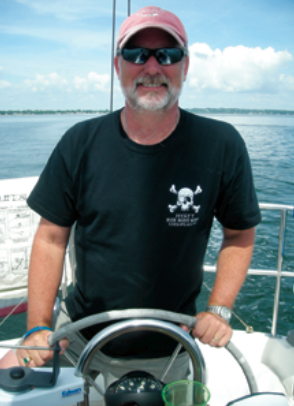 Picture of a man at a boat helm