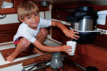 David’s grandson Jake demonstrates how a height-challenged but nimble crewmember obtains a draught of fresh water from the communal scuttlebutt aboard Ariel.