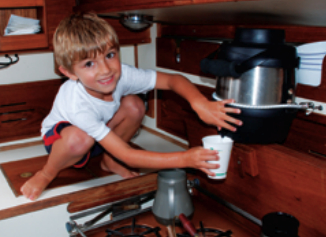 David’s grandson Jake demonstrates how a height-challenged but nimble crewmember obtains a draught of fresh water from the communal scuttlebutt aboard Ariel.
