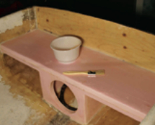 The stern seat has been glued into place and fillets of thickened epoxy applied wherever the seat meets the hull. The gelcoat on the inside of the hull has been ground back to the underlying laminate to provide a secure bond for the seat tabbing.