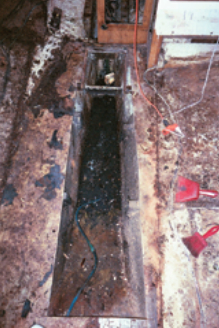 The old tank removed, the bilge awaits a cleanup and a new role.