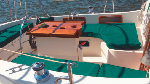 The T-shaped cockpit lets the helmsman move from rail to rail to see ahead and to view the headsail for proper trim. The pedestal with fold-out table leaves is fitted with cup holders as well.