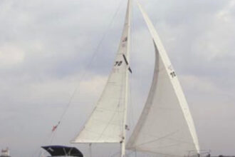 Solitude, a 1988 Aloha 32, is sailed by Wes and Sally Orloff, at left. Lake Erie’s Fairport Harbor Light is in the background.