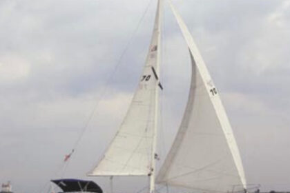 Solitude, a 1988 Aloha 32, is sailed by Wes and Sally Orloff, at left. Lake Erie’s Fairport Harbor Light is in the background.