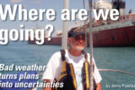 Man sailing next to a cargo ship