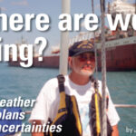 Man sailing next to a cargo ship