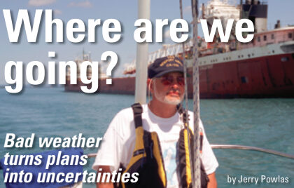 Man sailing next to a cargo ship