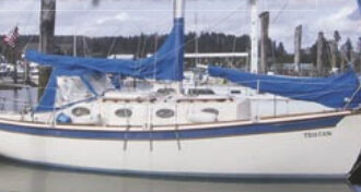 Tristan, a Mobile 27.8 Cruiser, decorates the dock above. The Binghams modified a Fred Bingham design and have just launched the fourth of these trailerable cruisers.