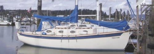 Tristan, a Mobile 27.8 Cruiser, decorates the dock above. The Binghams modified a Fred Bingham design and have just launched the fourth of these trailerable cruisers.