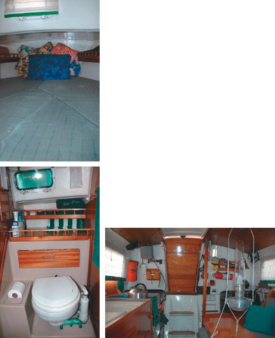 One way to close off the forepeak, at top, is to throw all the pillows forward! The molded fiberglass head module, at left, makes cleanup easy. The view aft, below, shows a lot of critical gear accessible from the companionway: EPIRB, fire extinguisher, radar, and flares.