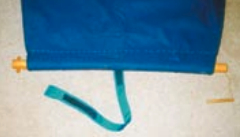The head of the Catnapper with the dowel inserted in the wide hem. Note the small dowels to hold it in place and the nylon strap.