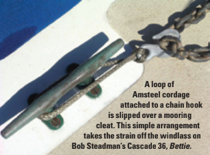 A loop of Amsteel cordage attached to a chain hook is slipped over a mooring cleat. This simple arrangement takes the strain off the windlass on Bob Steadman’s Cascade 36, Bettie.